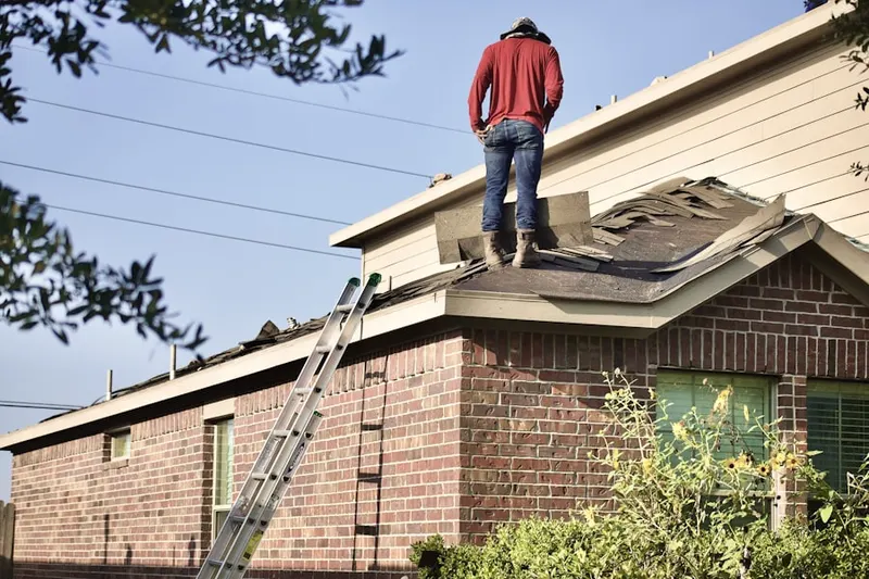 Professional roofer working on a residential roof in Roswell